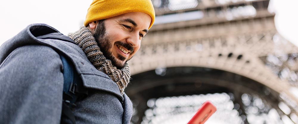 A man making payment on phone in Paris, France